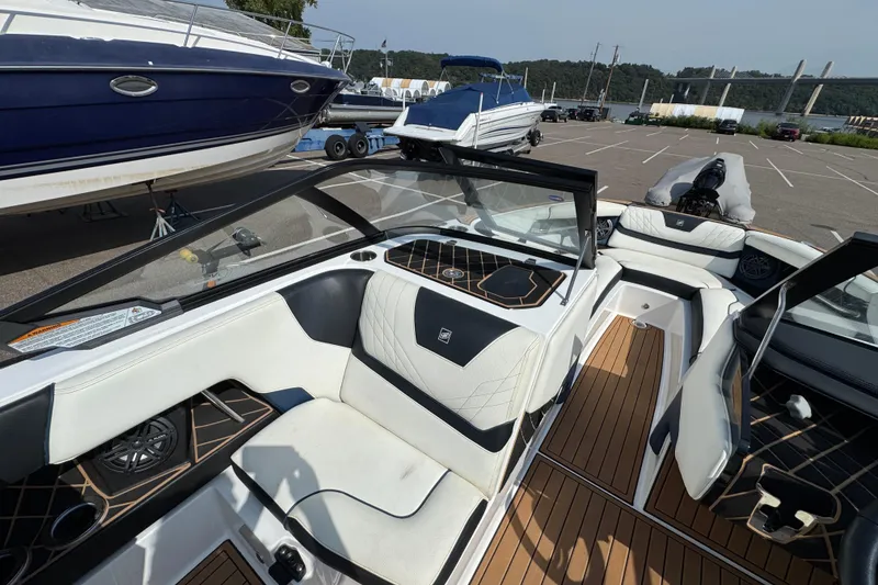 Slide: The Image of 2020 Nautique Super Air Nautique GS22 boat interior with teak flooring and metal fittings. - 31