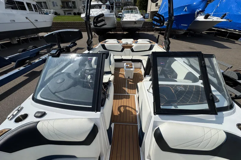 Slide: The Image of 2020 Nautique Super Air Nautique GS22 open storage compartment and engine view. - 34