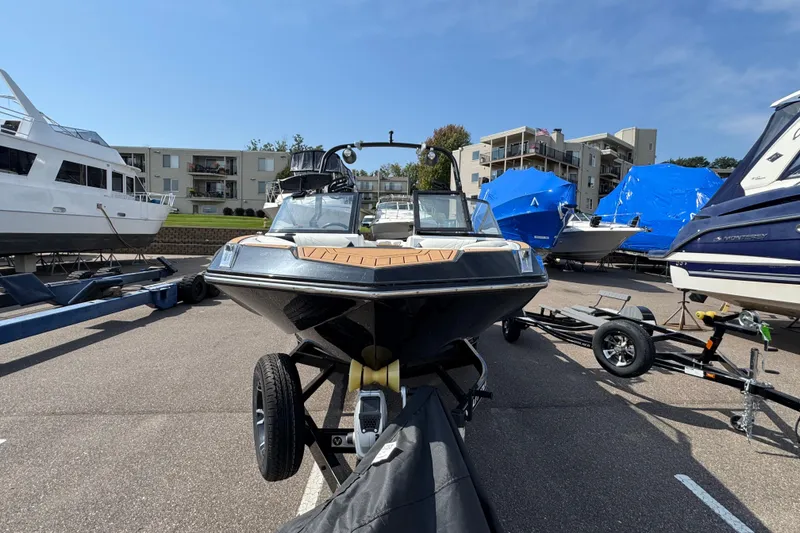 Slide: The Image of 2020 Nautique Super Air Nautique GS22 boat on trailer, rear view in parking lot. - 7