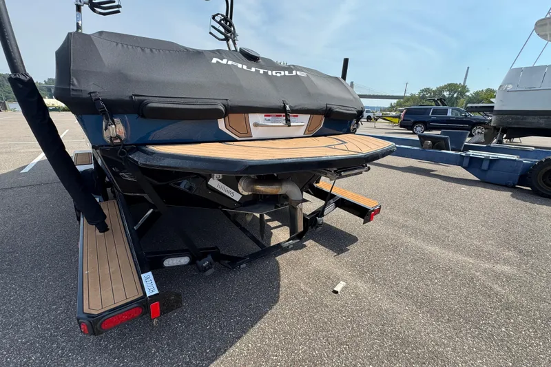 Slide: The Image of 2020 Nautique Super Air Nautique GS22 boat interior with white seating and wood accents. - 9