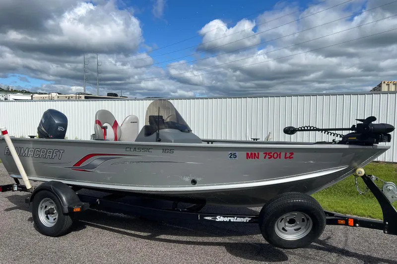 The Image of 2011 Alumacraft Classic 165 CS fishing boat on trailer, parked outdoors. - 0