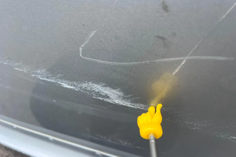 Slide: The Image of Close-up of scratches on a 2011 Alumacraft Classic 165 CS boat hull. - 12