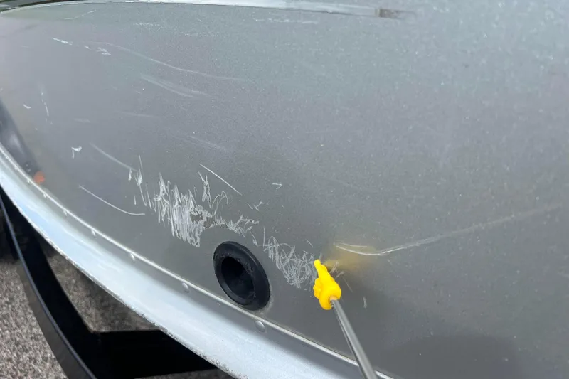 Slide: The Image of 2011 Alumacraft Classic 165 CS boat with visible scratches on the hull. - 13