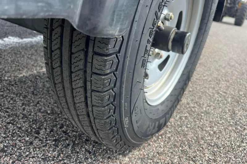 Slide: The Image of Close-up of a 2011 Alumacraft Classic 165 CS trailer tire on asphalt. - 15