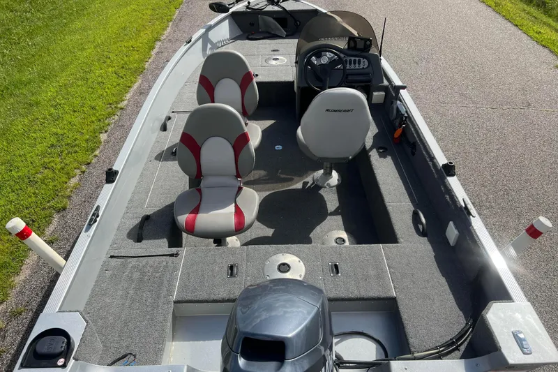 Slide: The Image of 2011 Alumacraft Classic 165 CS boat interior with seating and steering console. - 2