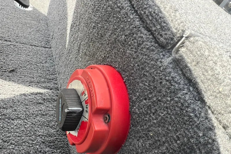 Slide: The Image of Red Perko switch on 2011 Alumacraft Classic 165 CS boat's carpeted interior. - 21