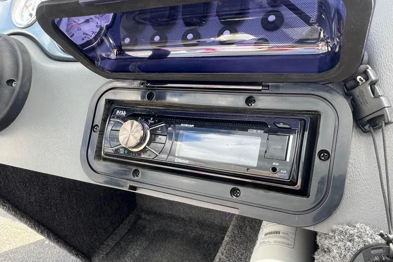 Slide: The Image of 2011 Alumacraft Classic 165 CS dashboard with stereo system and gauges. - 24