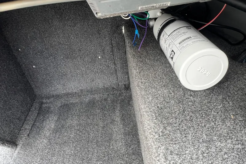 Slide: The Image of Interior of 2011 Alumacraft Classic 165 CS boat showing carpeted storage area. - 25