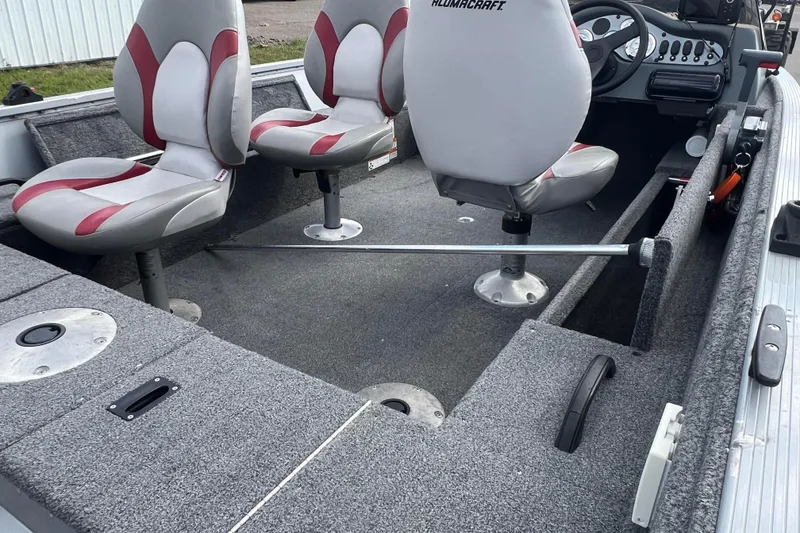 Slide: The Image of 2011 Alumacraft Classic 165 CS boat interior with gray and red seating. - 27