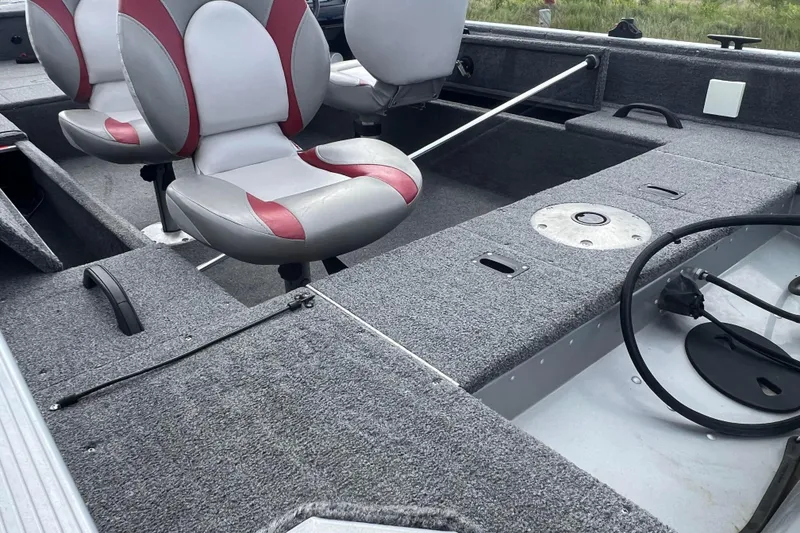 Slide: The Image of 2011 Alumacraft Classic 165 CS boat interior with gray and red seating. - 28