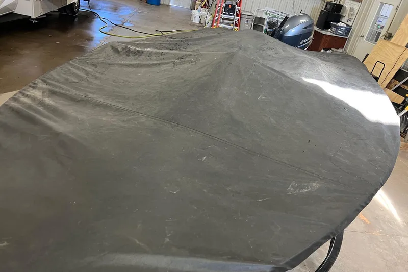 Slide: The Image of Covered 2011 Alumacraft Classic 165 CS boat in a garage setting. - 31