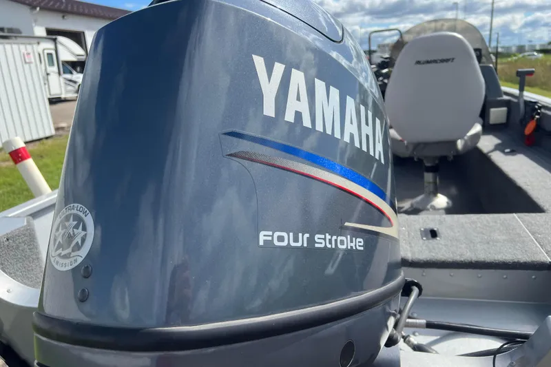 Slide: The Image of 2011 Alumacraft Classic 165 CS boat with Yamaha four-stroke engine, outdoor setting. - 4