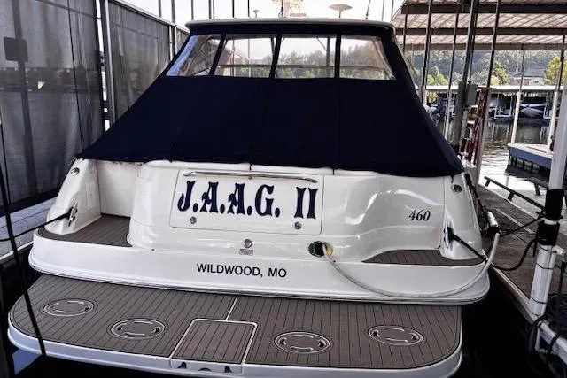 Slide: The Image of 2004 Sea Ray 460 Sundancer docked, rear view with cover, named "J.A.A.G. II," Wildwood, MO. - 12