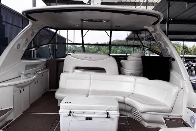 Slide: The Image of 2004 Sea Ray 460 Sundancer yacht interior with white seating and Yeti cooler. - 13