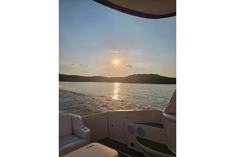 Slide: The Image of Sunset view from a 2004 Sea Ray 460 Sundancer boat on a serene lake. - 17