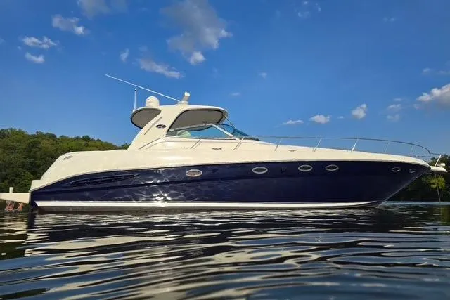 Slide: The Image of 2004 Sea Ray 460 Sundancer yacht on calm water under blue sky. - 2