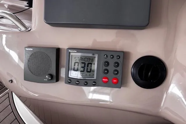Slide: The Image of Control panel of a 2004 Sea Ray 460 Sundancer boat, featuring navigation instruments. - 26