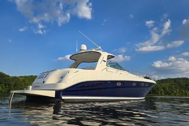 Slide: The Image of 2004 Sea Ray 460 Sundancer yacht on calm water under a clear blue sky. - 3