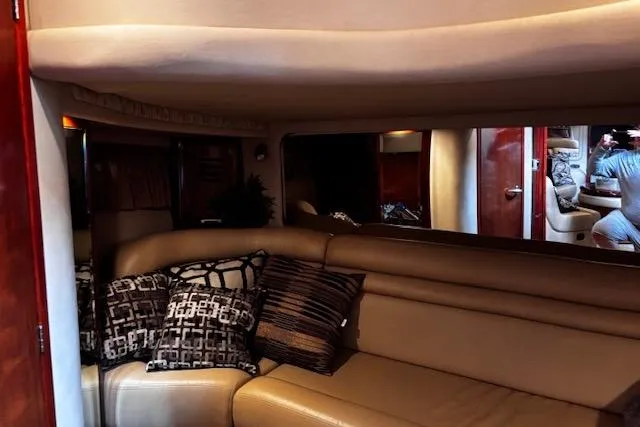 Slide: The Image of Interior of 2004 Sea Ray 460 Sundancer yacht with leather seating and decorative pillows. - 38