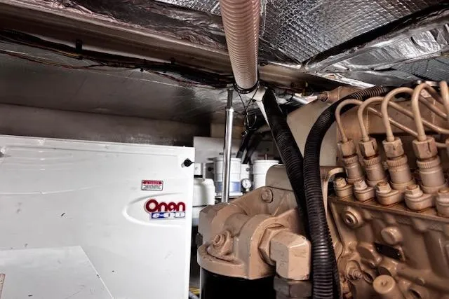 Slide: The Image of Engine room of 2004 Sea Ray 460 Sundancer with Onan generator and mechanical components. - 42