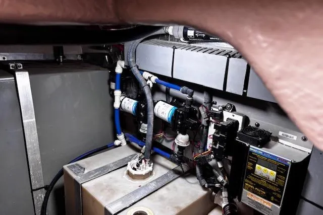 Slide: The Image of Engine compartment of a 2004 Sea Ray 460 Sundancer with visible wiring and components. - 46