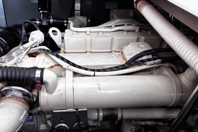 Slide: The Image of Engine compartment of a 2004 Sea Ray 460 Sundancer yacht, showcasing mechanical components. - 47