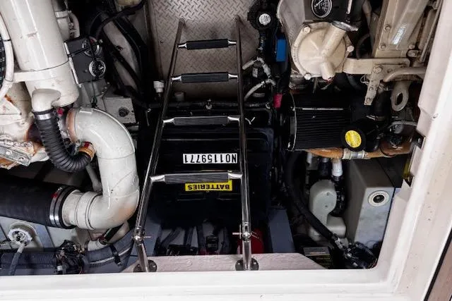 Slide: The Image of Engine compartment of a 2004 Sea Ray 460 Sundancer with visible components and ladder. - 48