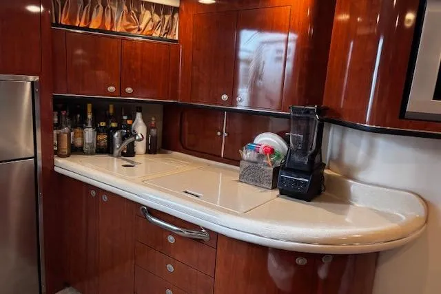 Slide: The Image of Luxurious 2004 Sea Ray 460 Sundancer yacht kitchen with wood cabinetry and modern appliances. - 53