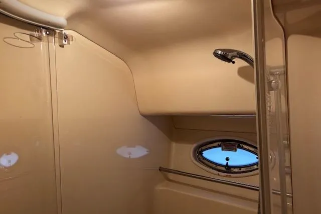 Slide: The Image of Interior of 2004 Sea Ray 460 Sundancer yacht bathroom with shower and porthole window. - 54