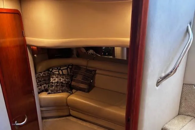 Slide: The Image of Interior of 2004 Sea Ray 460 Sundancer yacht with beige leather seating and decorative pillows. - 58