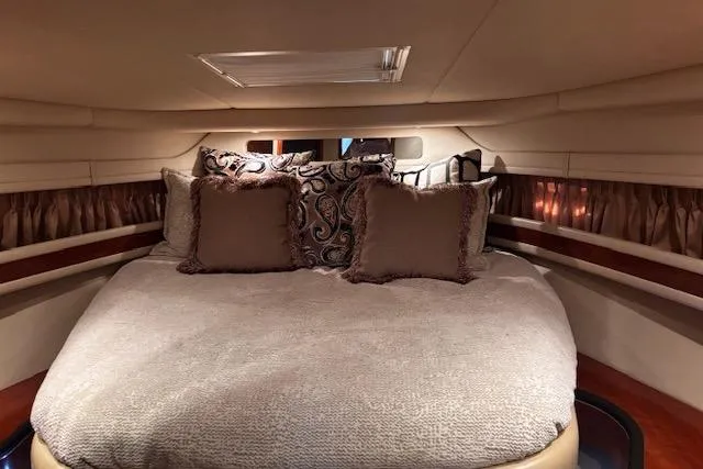 Slide: The Image of Luxurious cabin interior of 2004 Sea Ray 460 Sundancer yacht with plush bedding. - 59