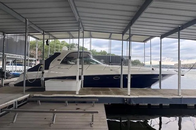 Slide: The Image of 2004 Sea Ray 460 Sundancer yacht docked under a covered marina. - 6