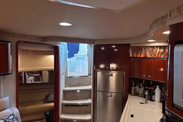 Slide: The Image of Interior of 2004 Sea Ray 460 Sundancer yacht with kitchen and seating area. - 60