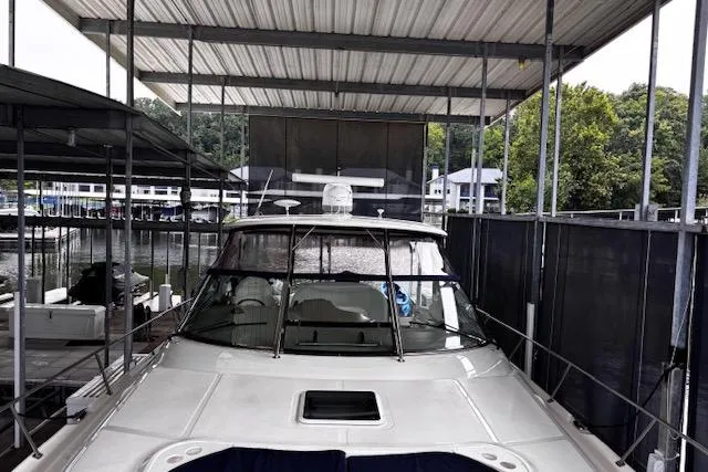 Slide: The Image of 2004 Sea Ray 460 Sundancer yacht docked under covered marina. - 8