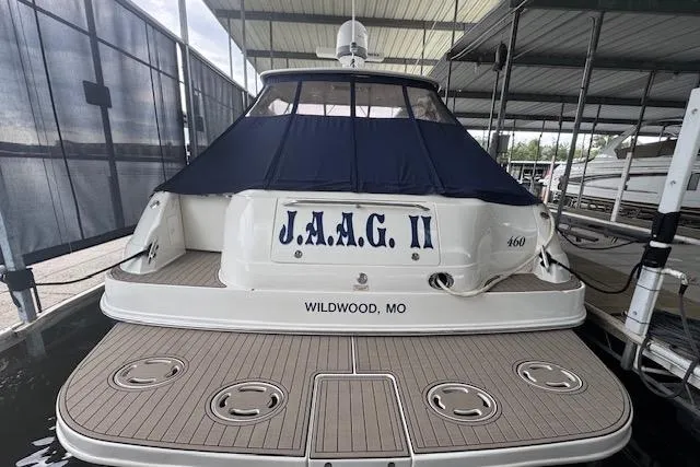 Slide: The Image of 2004 Sea Ray 460 Sundancer docked, rear view with custom name "J.A.A.G. II" and location "Wildwood, MO". - 9