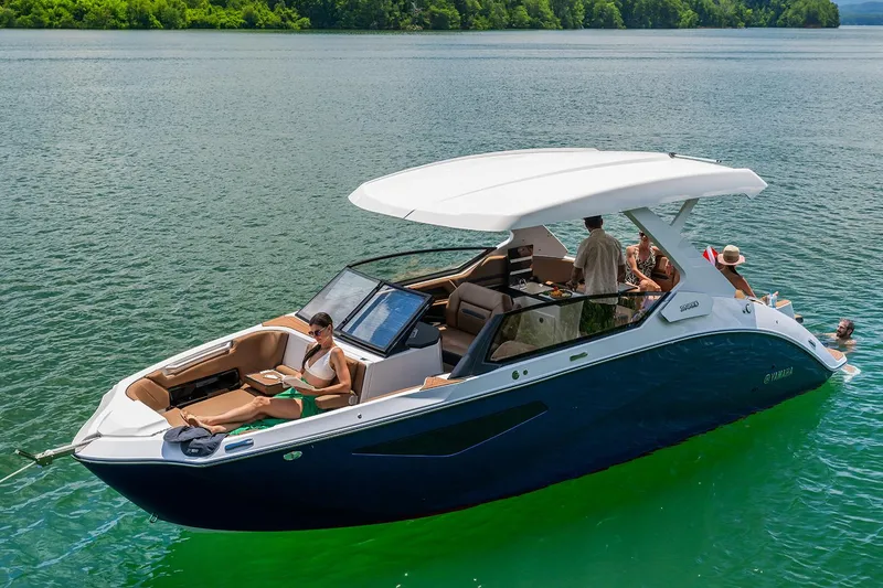 Slide: The Image of Interior of 2026 Yamaha Boats 295SD, showcasing luxurious seating and modern design at a boat show. - 11