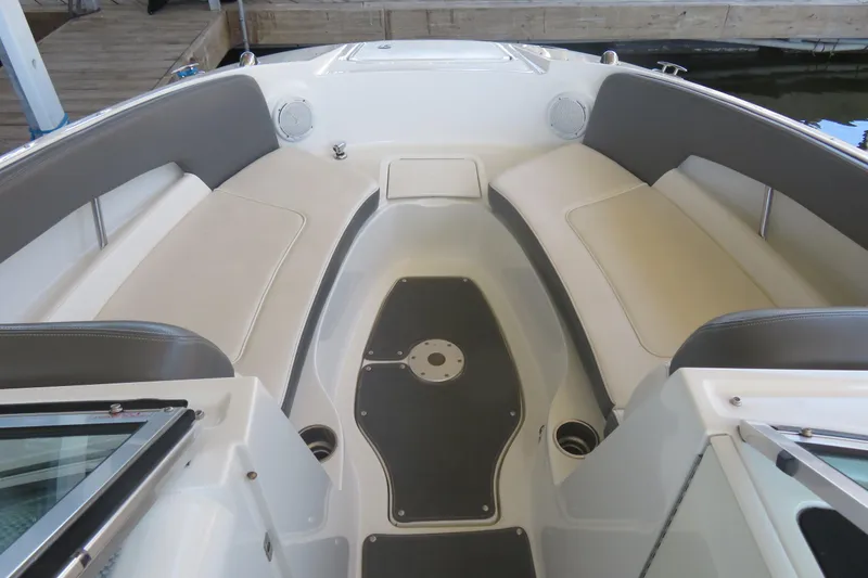 Slide: The Image of 2011 Sea Ray 240 Sundeck interior with spacious seating and sleek design. - 2