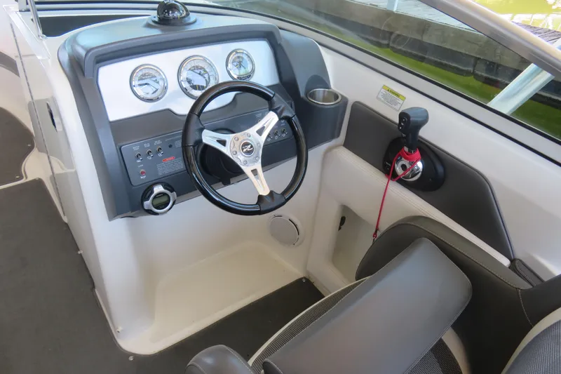 Slide: The Image of 2011 Sea Ray 240 Sundeck dashboard with steering wheel and control panel. - 3