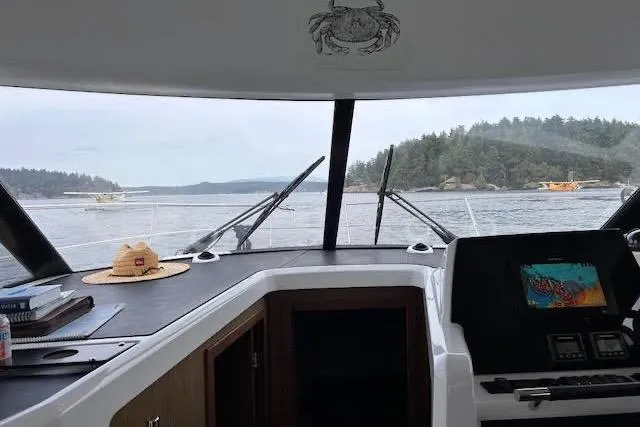 Slide: The Image of Interior view from a 2019 Jeanneau Velasco 37F boat, overlooking a scenic waterway. - 14