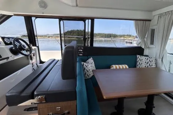 Slide: The Image of Interior of 2019 Jeanneau Velasco 37F yacht with dining area and scenic window view. - 15