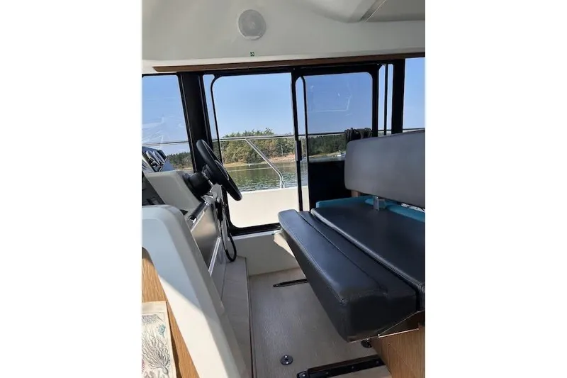 Slide: The Image of Interior view of 2019 Jeanneau Velasco 37F boat with steering wheel and seating. - 20