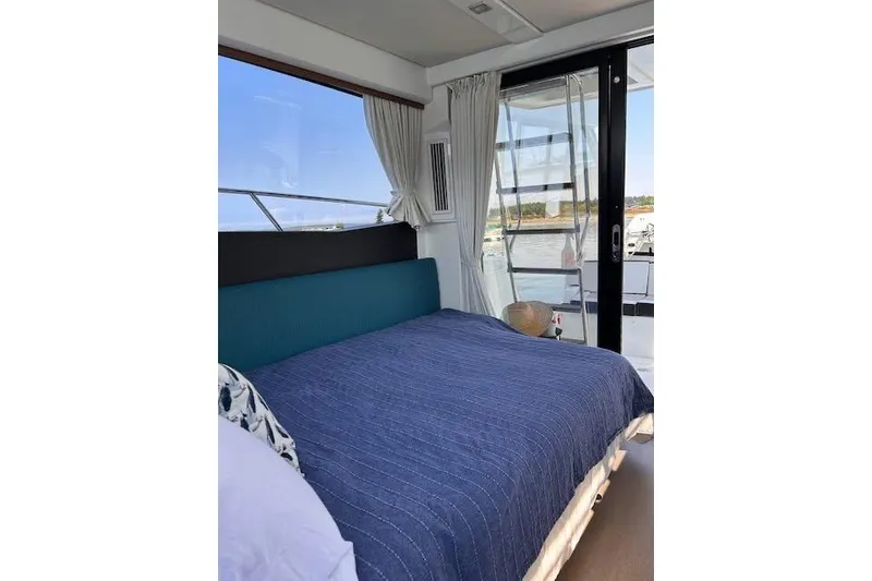Slide: The Image of Interior of 2019 Jeanneau Velasco 37F yacht with cozy bed and scenic window view. - 24