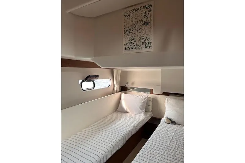 Slide: The Image of Interior cabin of 2019 Jeanneau Velasco 37F with twin beds and nautical decor. - 29