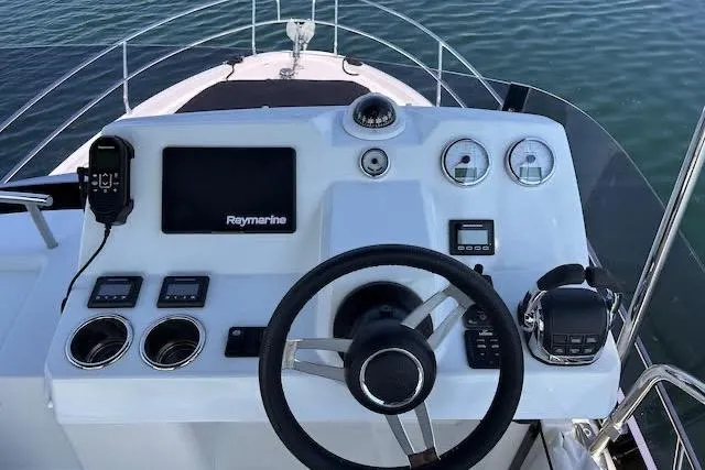 Slide: The Image of Helm of 2019 Jeanneau Velasco 37F with Raymarine electronics, steering wheel, and controls. - 35