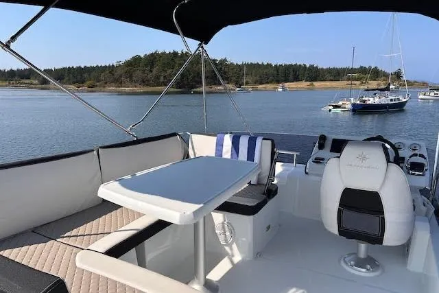 Slide: The Image of 2019 Jeanneau Velasco 37F yacht interior with seating and table, overlooking serene waters. - 36