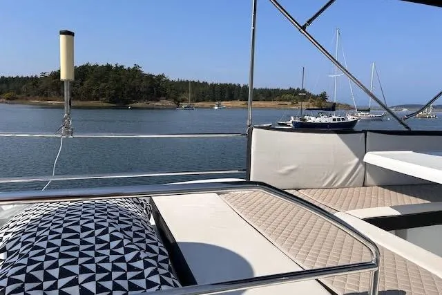 Slide: The Image of 2019 Jeanneau Velasco 37F yacht with scenic waterfront view and comfortable seating. - 40