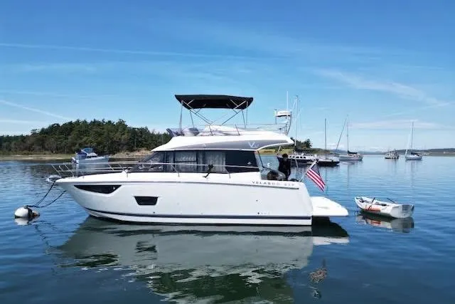 Slide: The Image of 2019 Jeanneau Velasco 37F yacht on calm water with scenic background. - 5