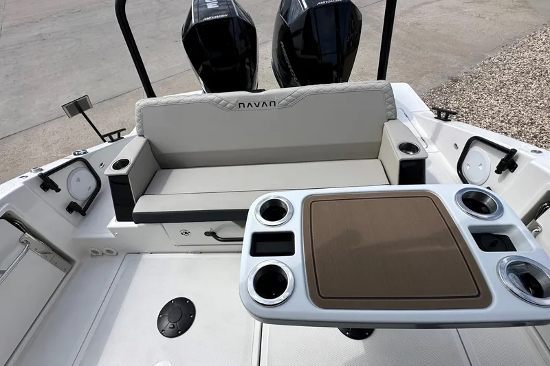 Slide: The Image of 2025 Navan C30 boat interior with seating and storage, docked at a marina. - 12