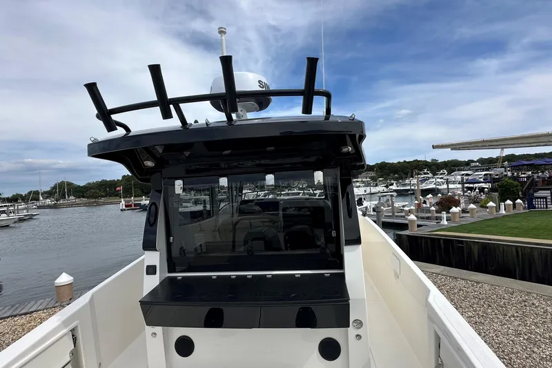 Slide: The Image of 2025 Navan C30 boat interior with foldable seat and sleek design at marina. - 14