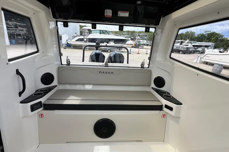 Slide: The Image of 2025 Navan C30 boat docked at marina, showcasing rear view and fishing rod holders. - 17